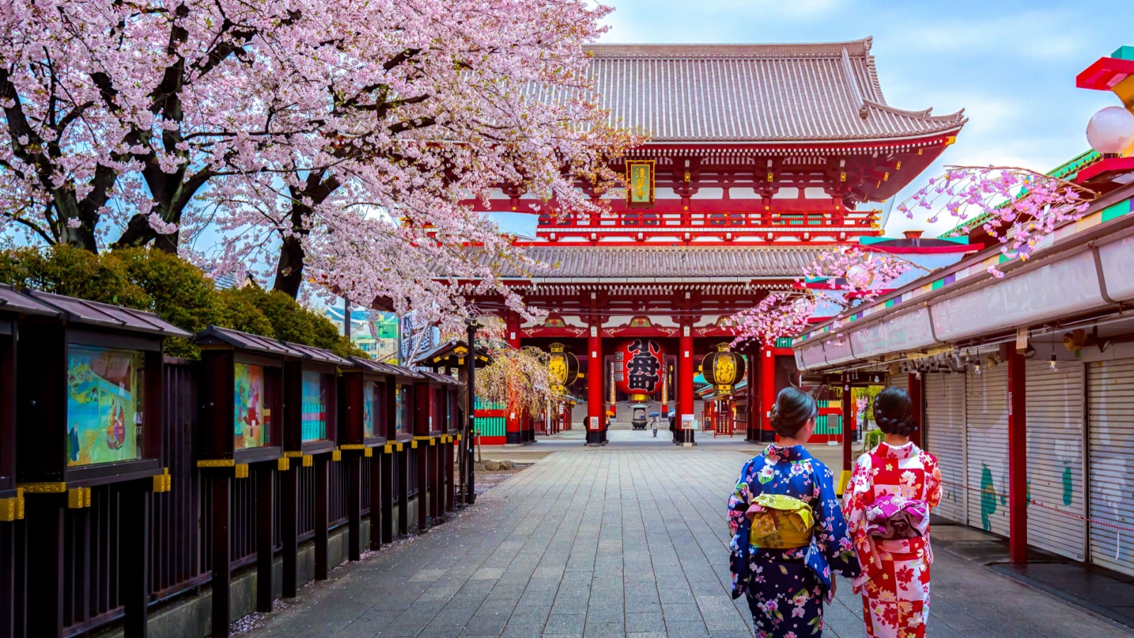 Two geishas wearing traditional japanese kimono among Sensoji Temple in Asakusa Tokyo, Japan.