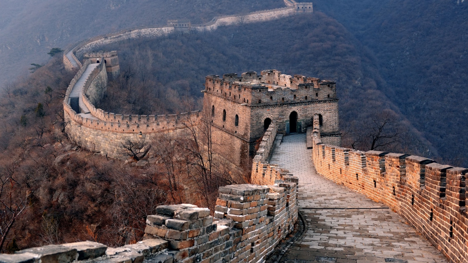 Great Wall sunset over mountains in Beijing, China.