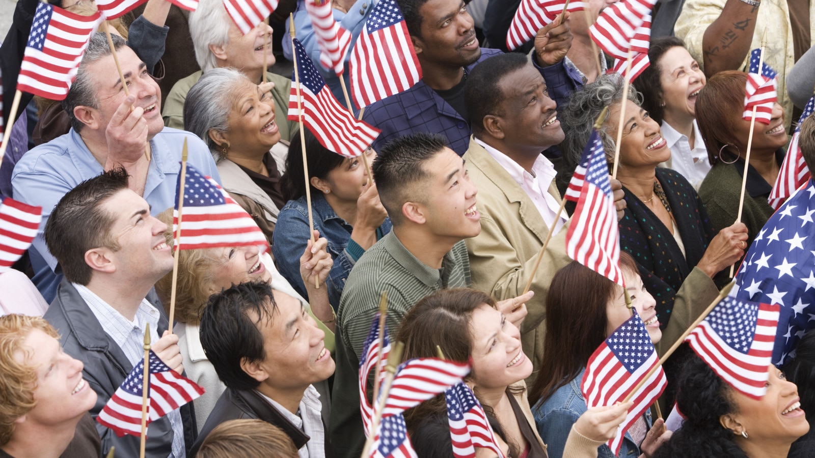 High angle view of happy multi ethnic people holding American flag