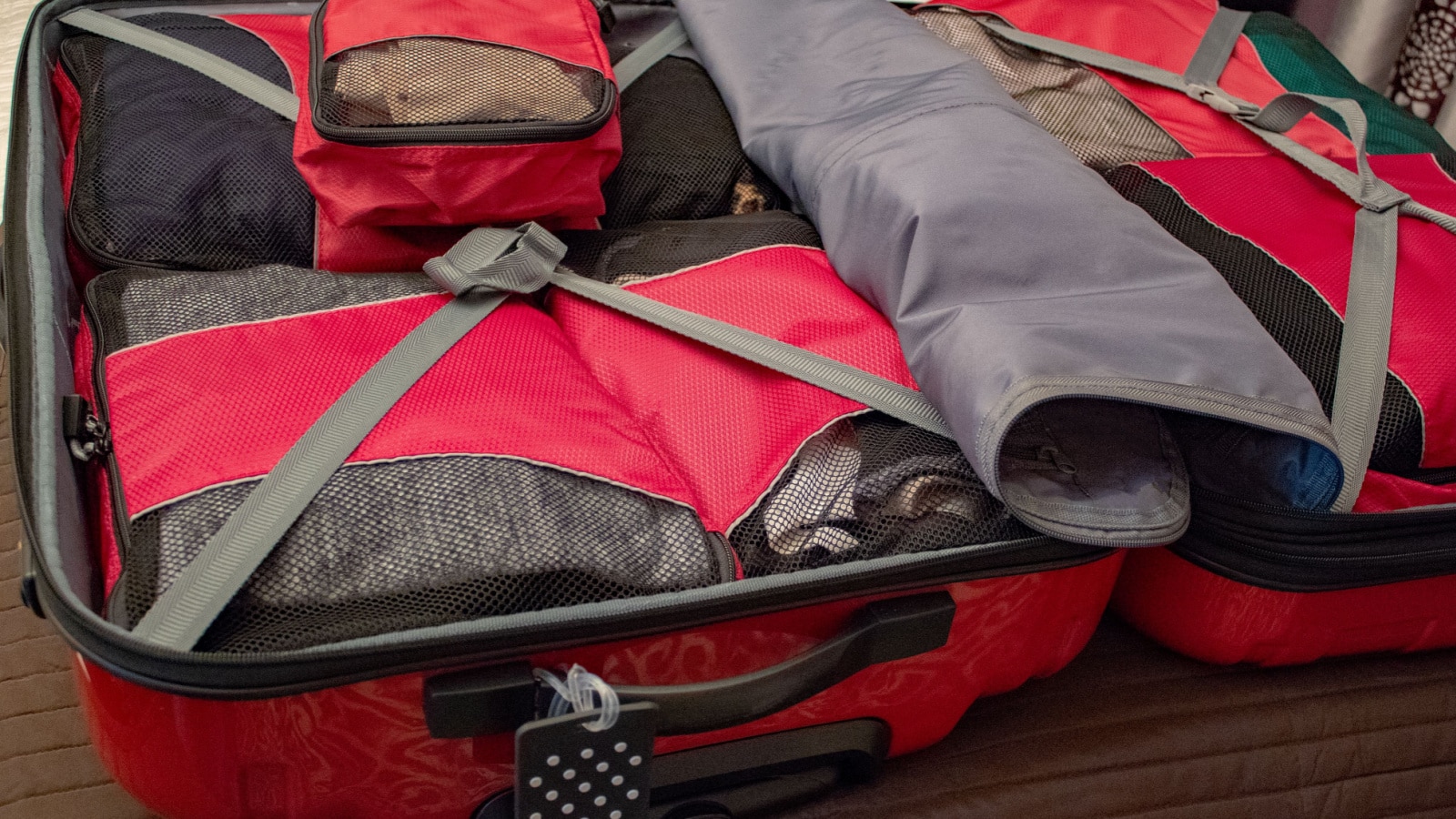 An open suitcase with packing organizers. Packing for vacation.