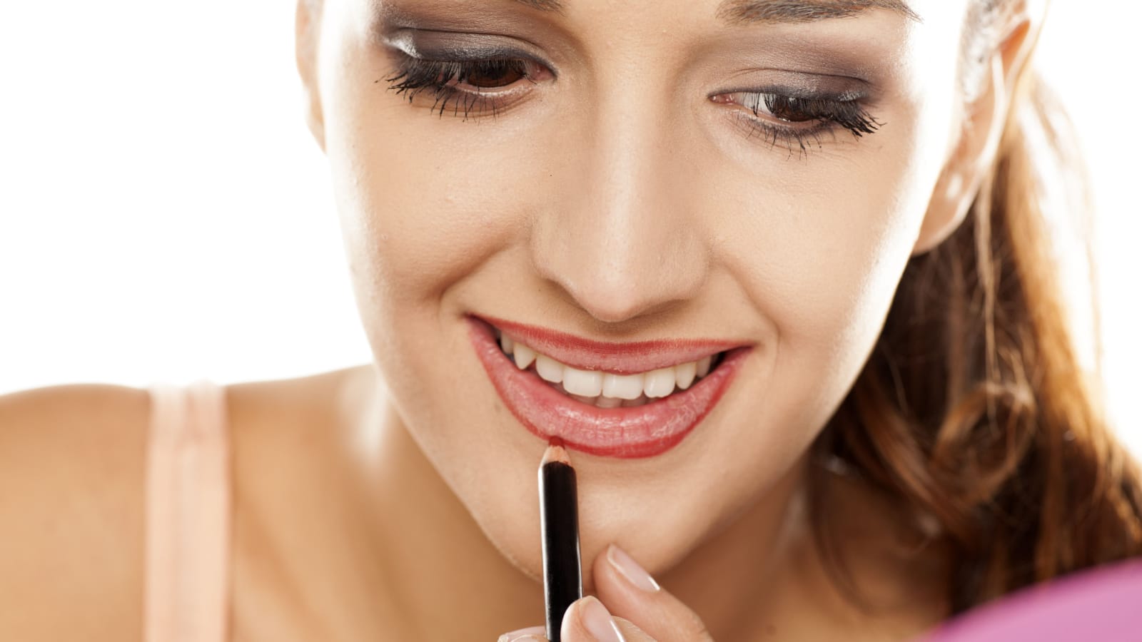 young woman applied contour on her lips with a pencil