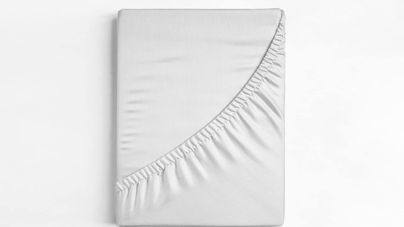 Flat sheet or bed cover folded. White fitted sheet against a white background. White sheet with elastic band.