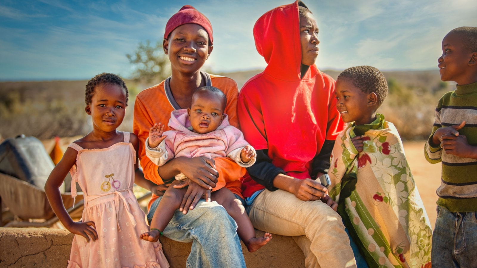 African family group of kids and teenagers, village in Botswana