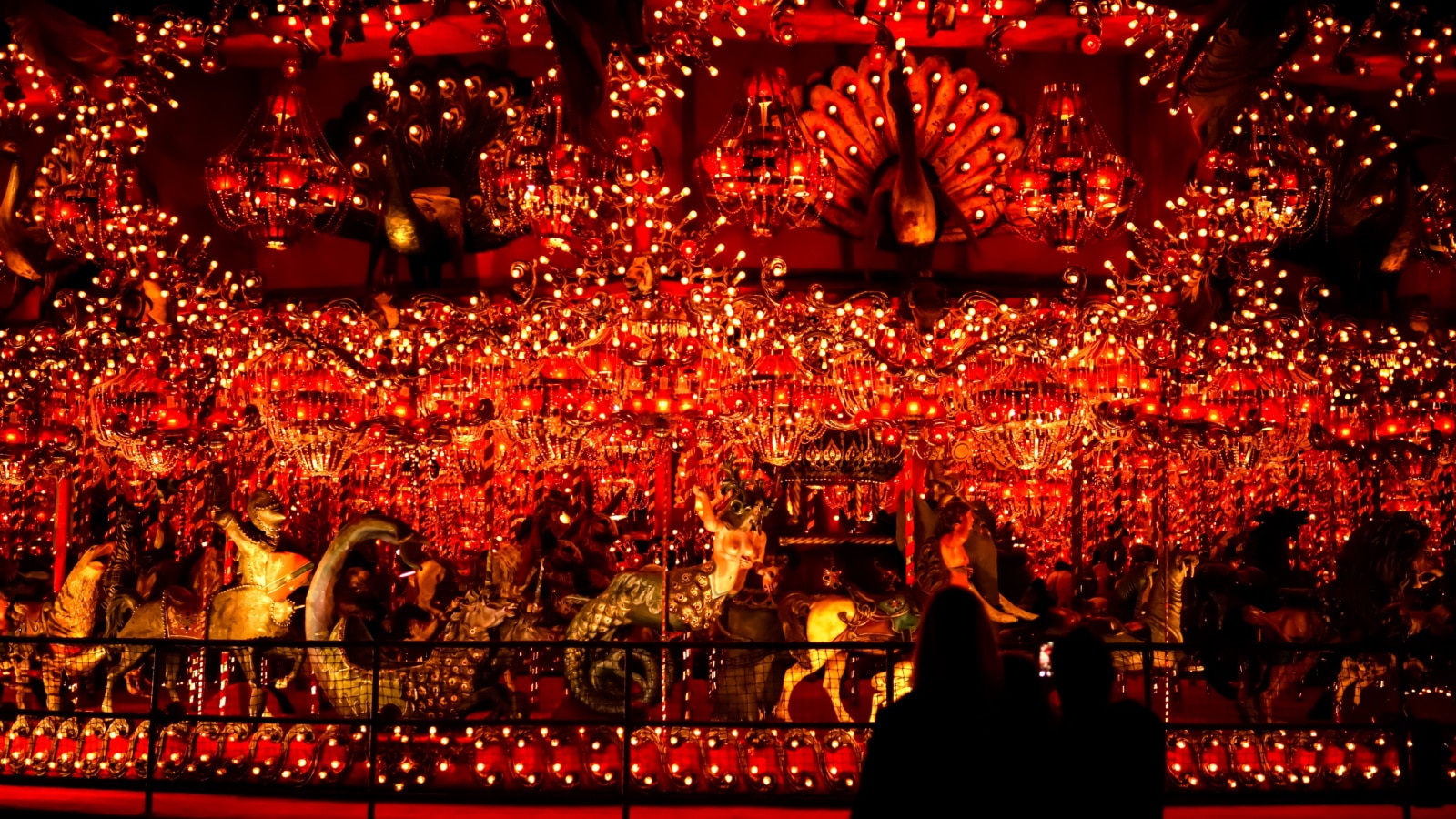 Wisconsin, USA; June 17, 2019: Visitors look at the carousel at the House on a Rock tourist attraction, with its dazzling lights and mythical creatures; the largest indoor carousel in the world.