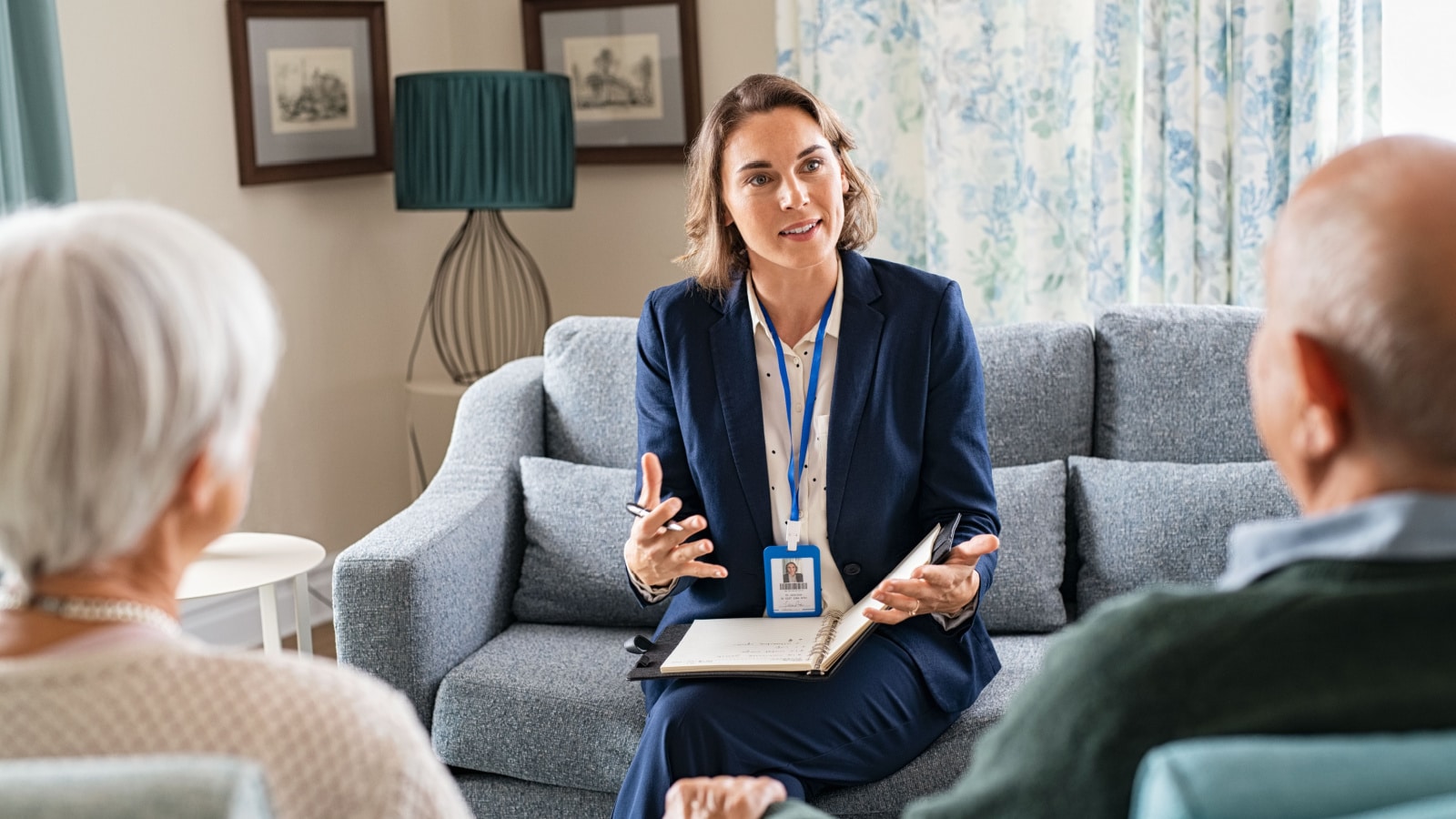 Social worker, talking to old man and woman for insurance plans on retirement. Happy supporter with senior people during a home consultation: counseling and psychological session at home.