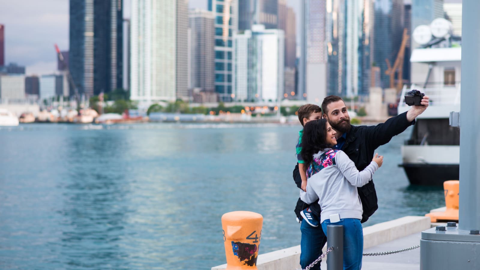 CHICAGO, IL, July 14, 2017: A family takes a selfie at the iconic Navy Pier, with the Chicago skyline in the distance. Navy Pier attracts millions of visitors each year.