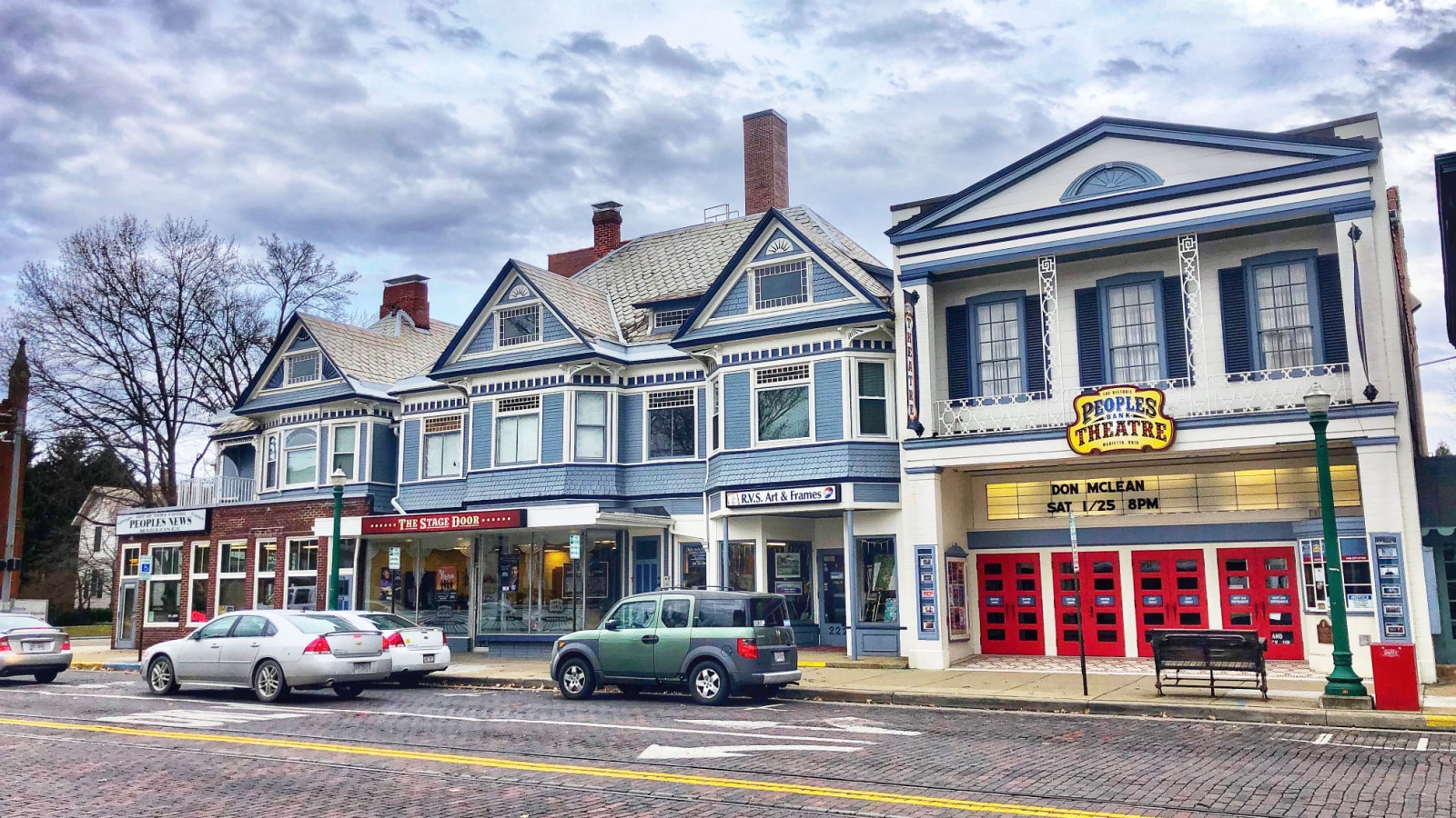 Marietta, Ohio, USA, Jan. 11, 2020: Street view of downtown Marietta with cars parked at curb and the People’s Bank Theatre seen prominently.