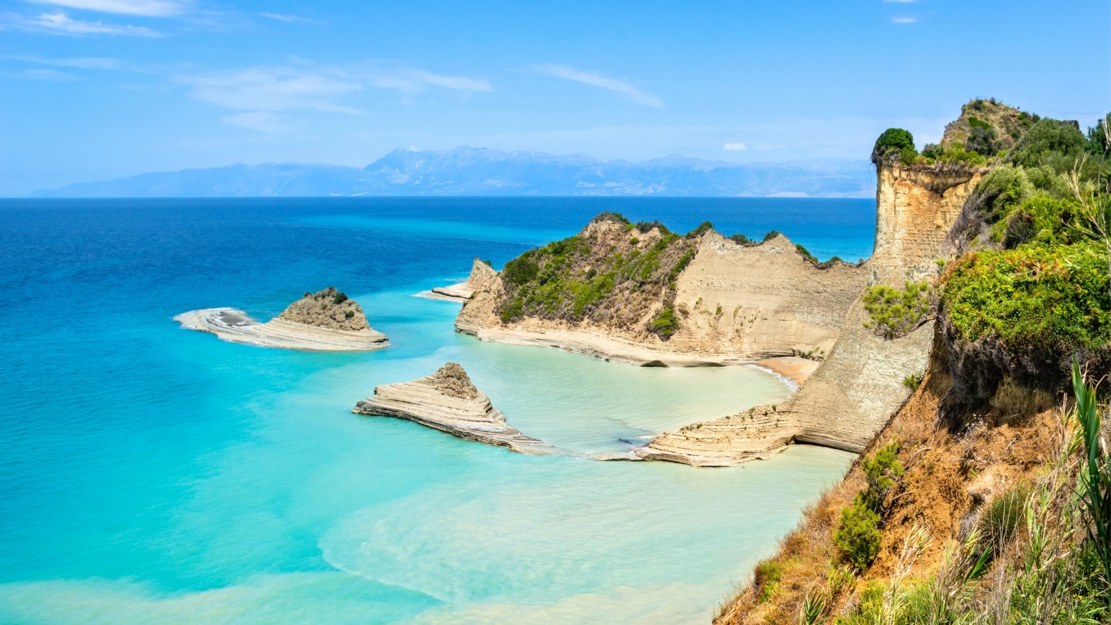 Cape Drastis cliffs near Sidari and Peroulades on Corfu island in Greece. Famous rock formations with small beach and rugged coastline. Popular Greek destination for summer vacation