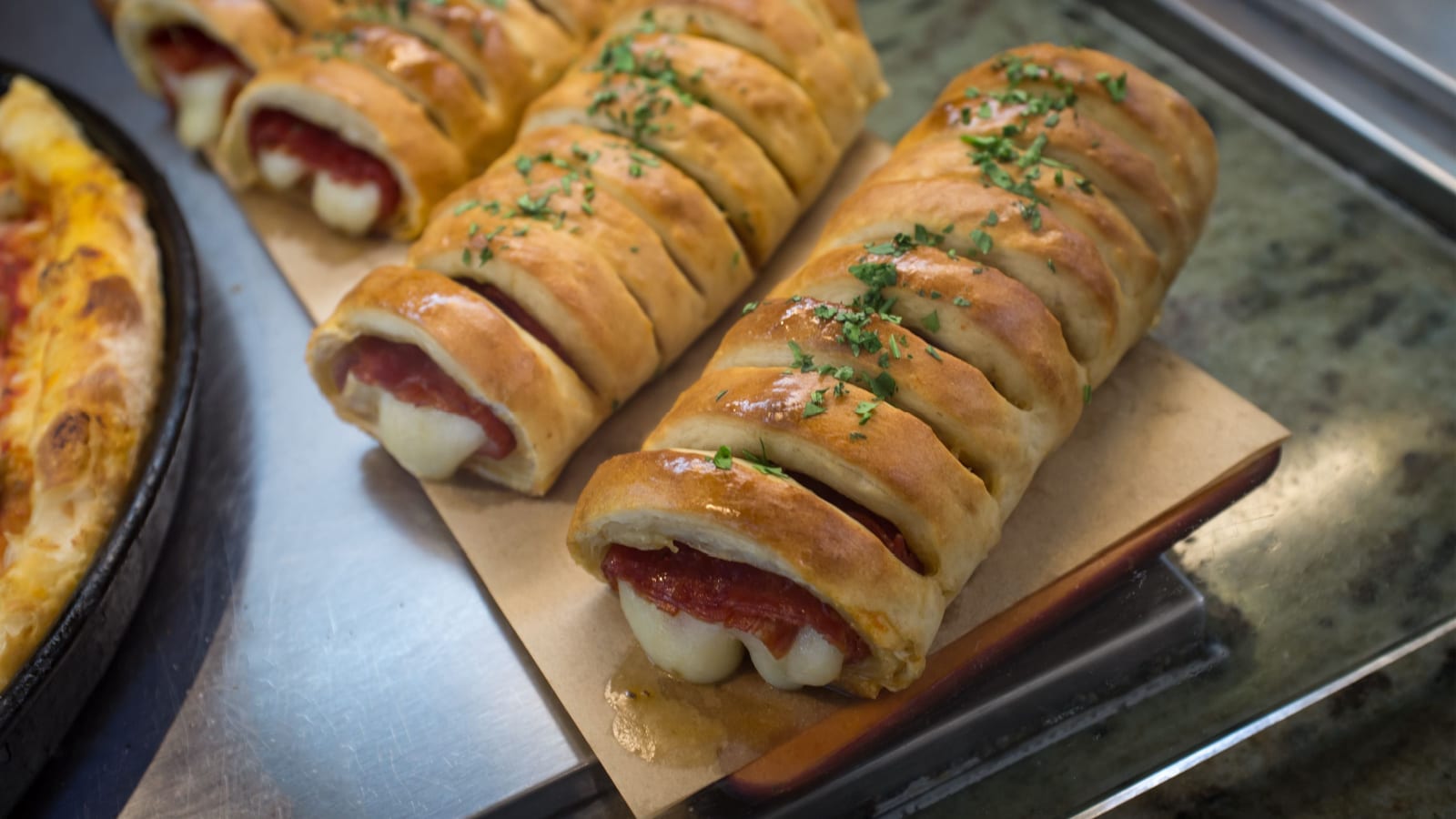 Fresh hot pepperoni and cheese Italian stromboli on display