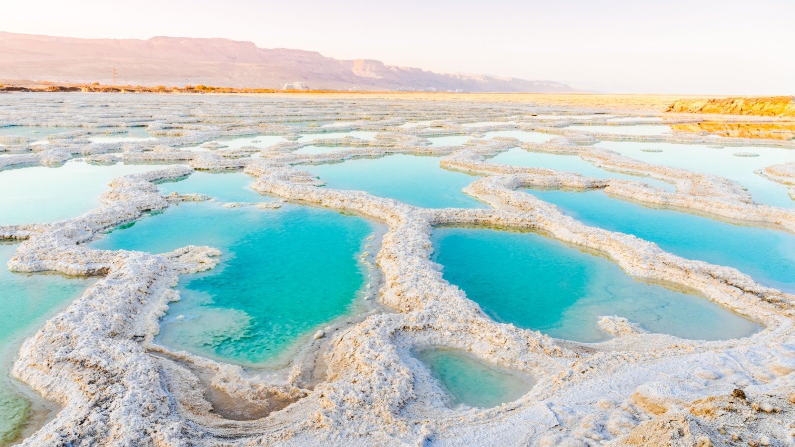 View of Dead Sea coastline. Salt crystals at sunset. Texture of Dead sea. Salty sea shore