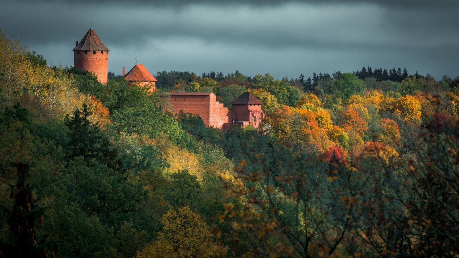 Picturesque view on valley of Gaujas national park. Trees changing colors in foothills. Colorful Autumn day at city Sigulda in Latvia.