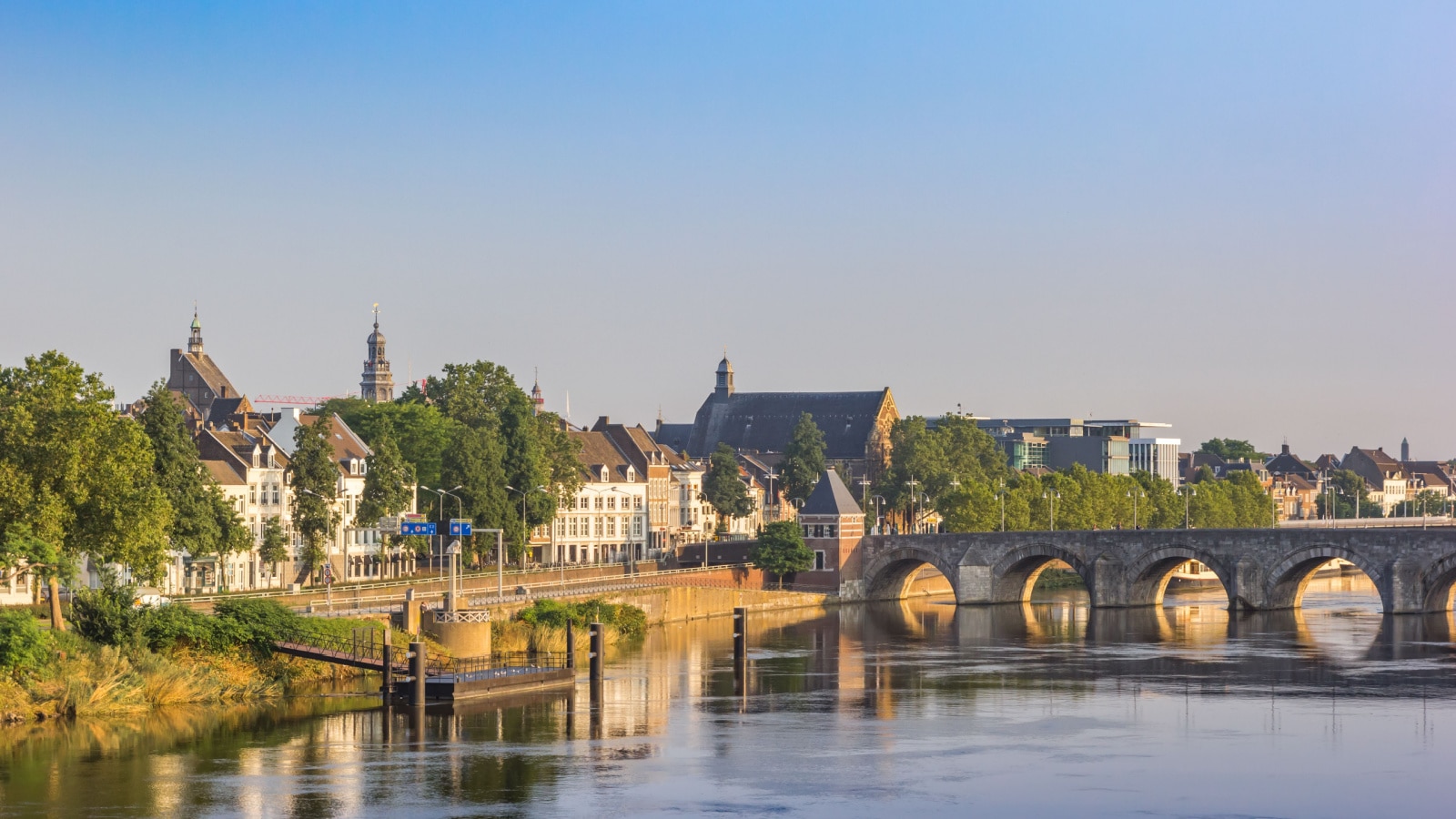 Historic Servaas bridge over river Maas at dawn in Maastricht, Netherlands