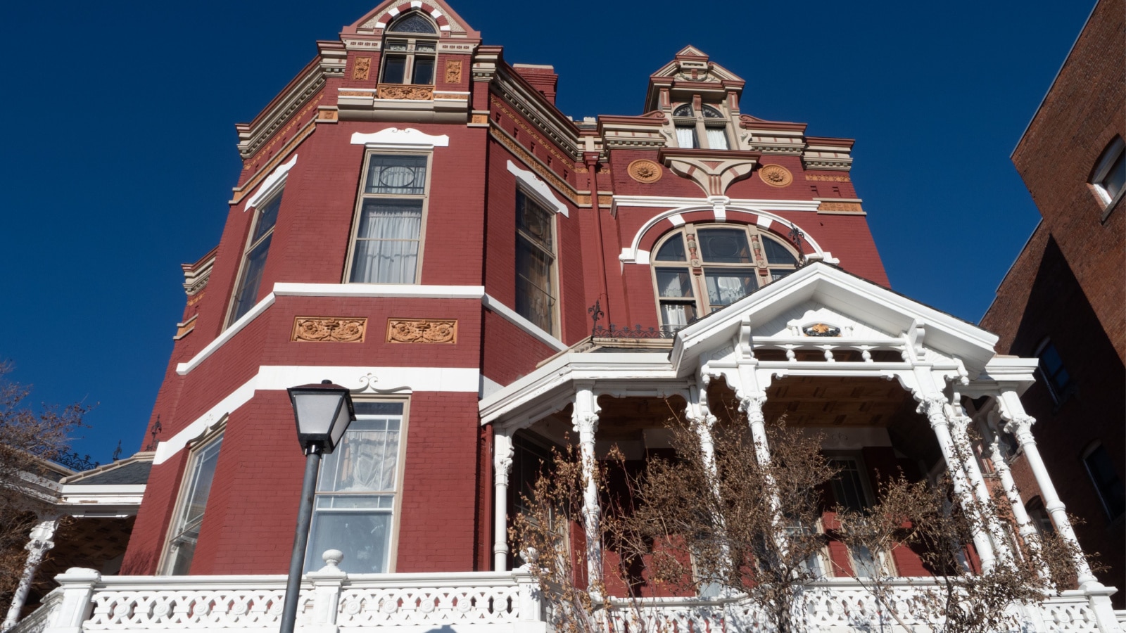 Butte, MT USA - December 28, 2020: Red brick exterior with white trim on the Copper King or W.A. Clark Mansion in Butte, Montana.