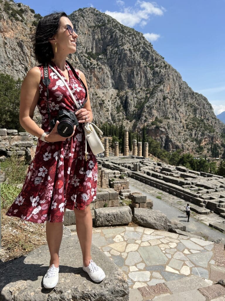 Lindsey wearing a floral Karina dress and white keds in Delphi Greece