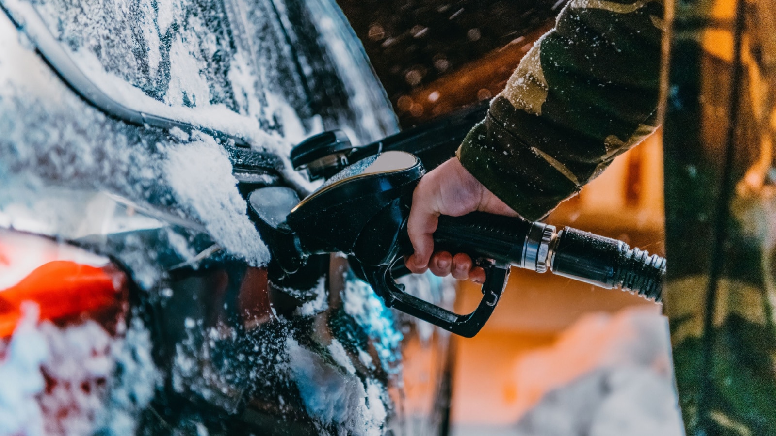 Refuelling diesel gas on petrol station at winter