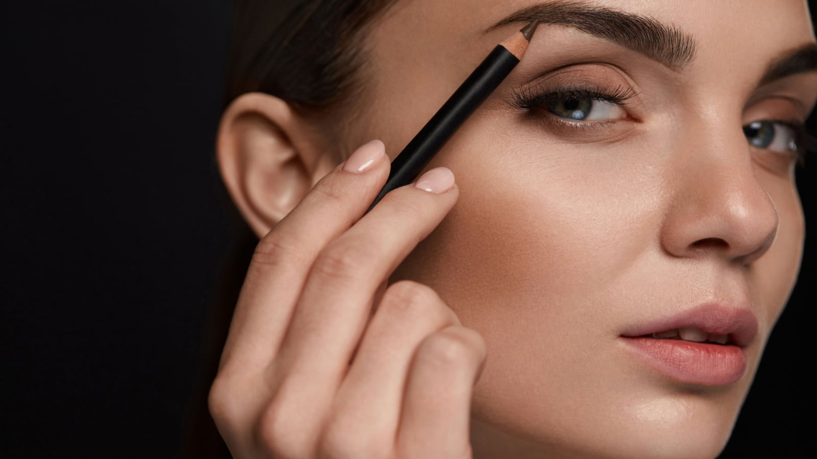 Eyebrows Shaping. Portrait Of Sexy Young Girl With Brow Pencil. Closeup Of Beautiful Glamourous Woman With Professional Makeup Contouring Brows With Eyebrow Pencil. Beauty Concept. High