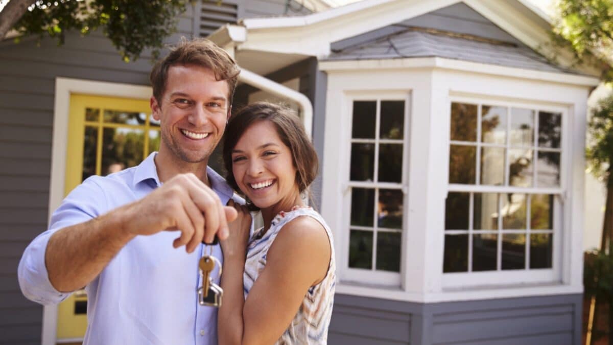 Couples with keys buying house