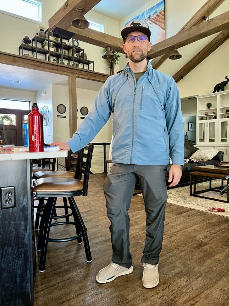 Zac wearing a blue SCOTTeVEST jacket and grey SCOTTeVEST Joggers