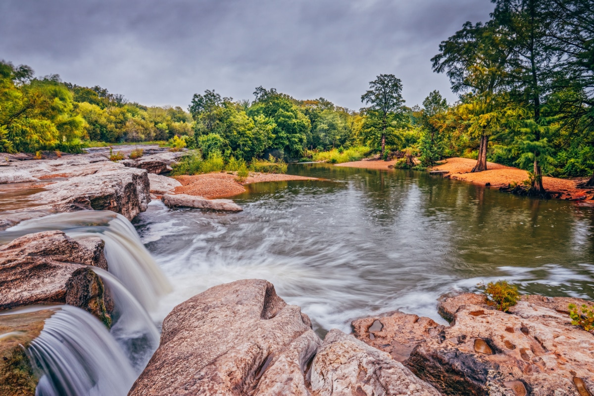 Onion Creek Spilling Over Limestone Ledge at Lower Falls McKinney Falls State Park Austin Texas