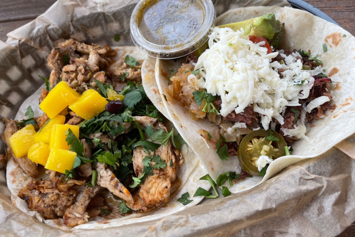 Austin, Texas USA - 04.16.2021: Delicious chicken and brisket taco at Torchy's Tacos tex mex restaurant in Austin, TX.