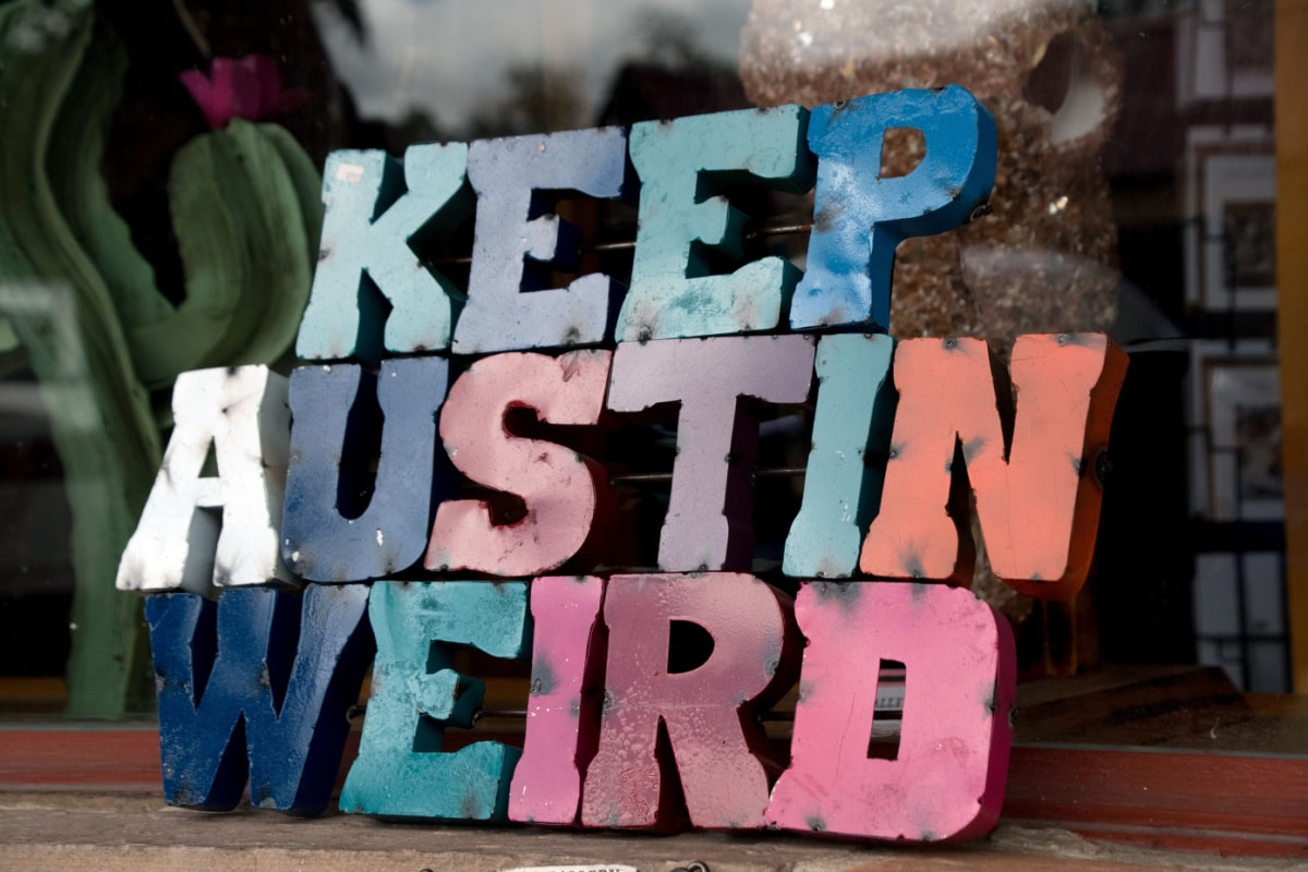 Colorful plate with word Austin in front of a shop window in SoCo, Austin