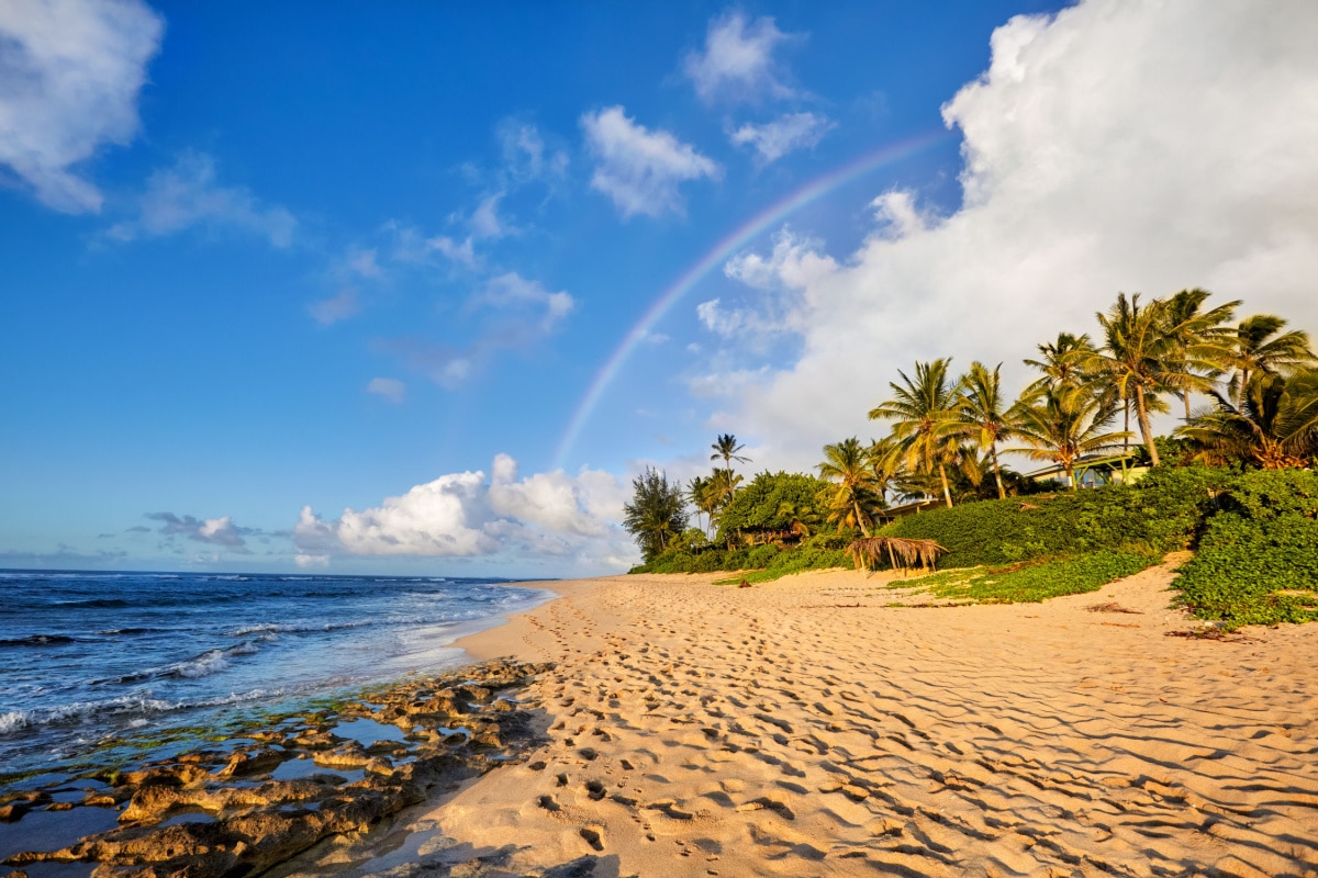 rainbow scenic view over the popular surfing place Sunset Beach, North Shore, Oahu, Hawaii, USA