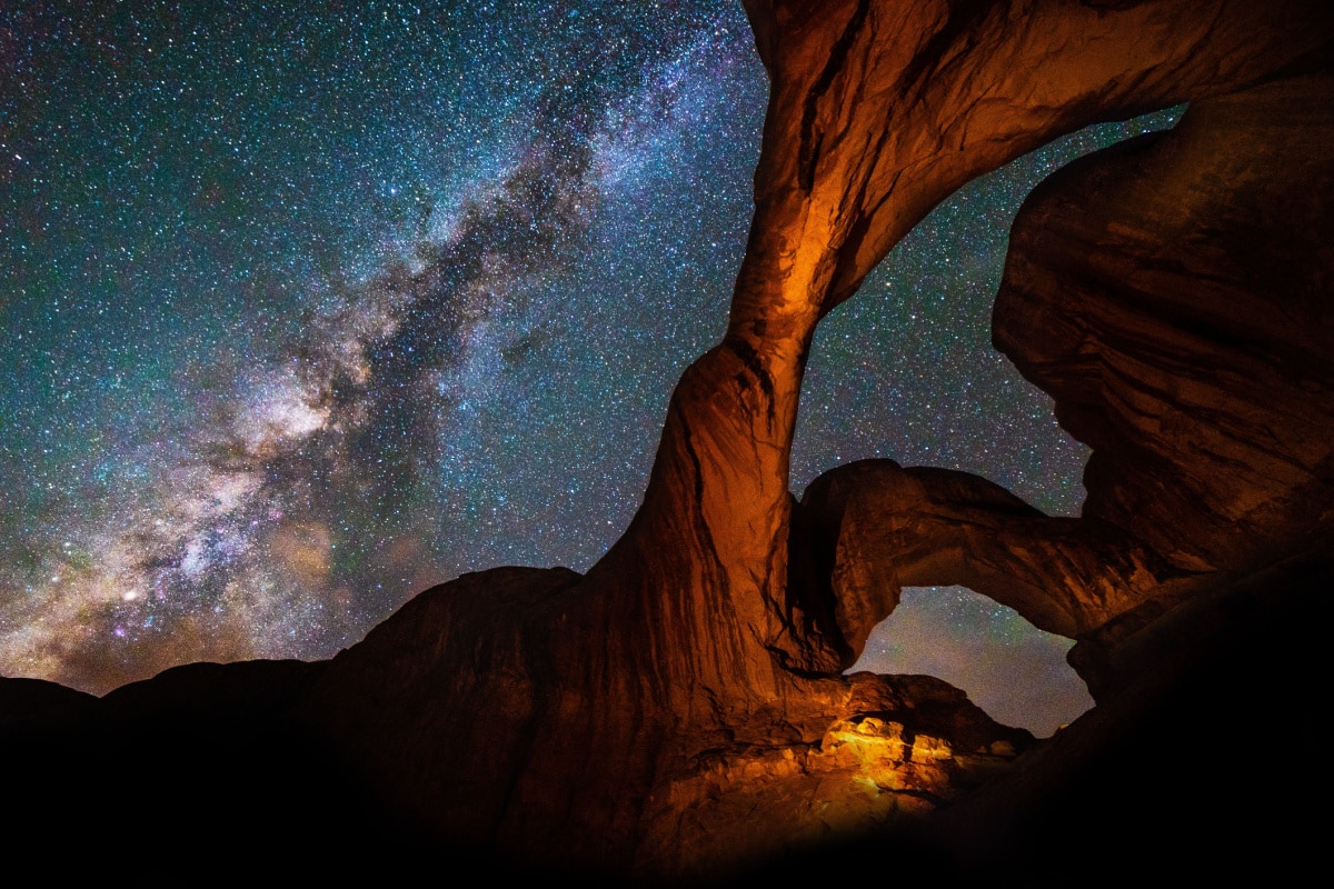 Milky Way Galaxy behind Double Arch sandstone rock formation in Arches, National Park, Utah