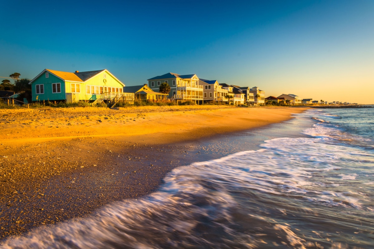 Waves in the Atlantic Ocean and morning light on beachfront homes at Edisto Beach, South Carolina.