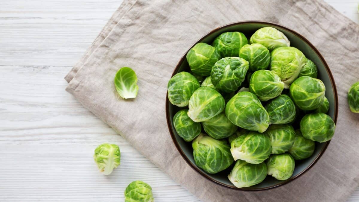 Raw Organic Brussel Sprouts in a Bowl, top view. Flat lay, overhead, from above. Copy space.