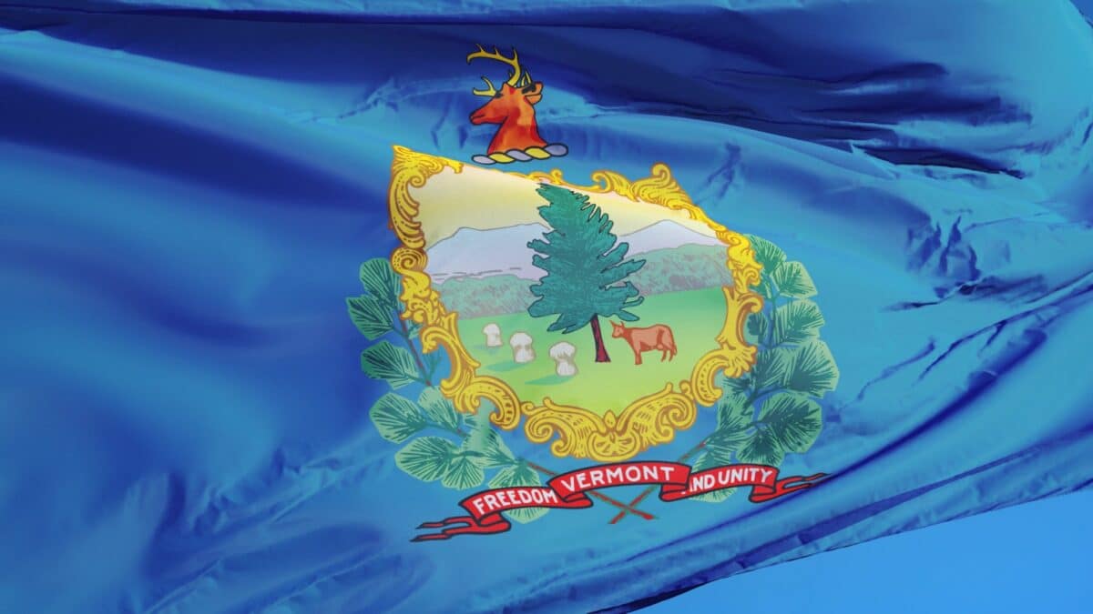 Vermont (U.S. state) flag waving against clear blue sky, close up, isolated with clipping path mask alpha channel transparency, perfect for film, news, composition