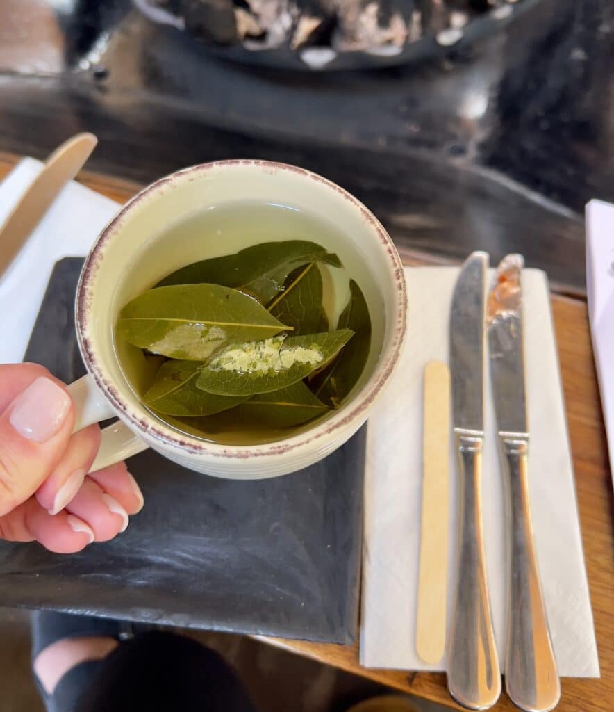 Lindsey holding a cup of coca tea in Cusco, Peru