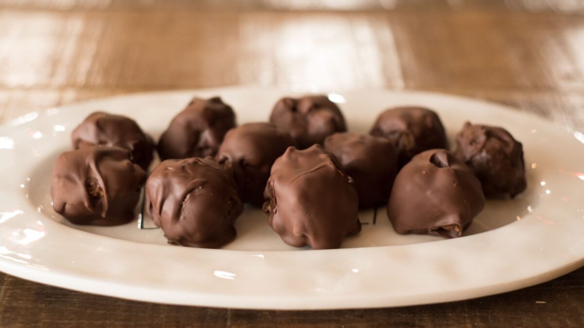 Chocolate bourbon balls on white plate.