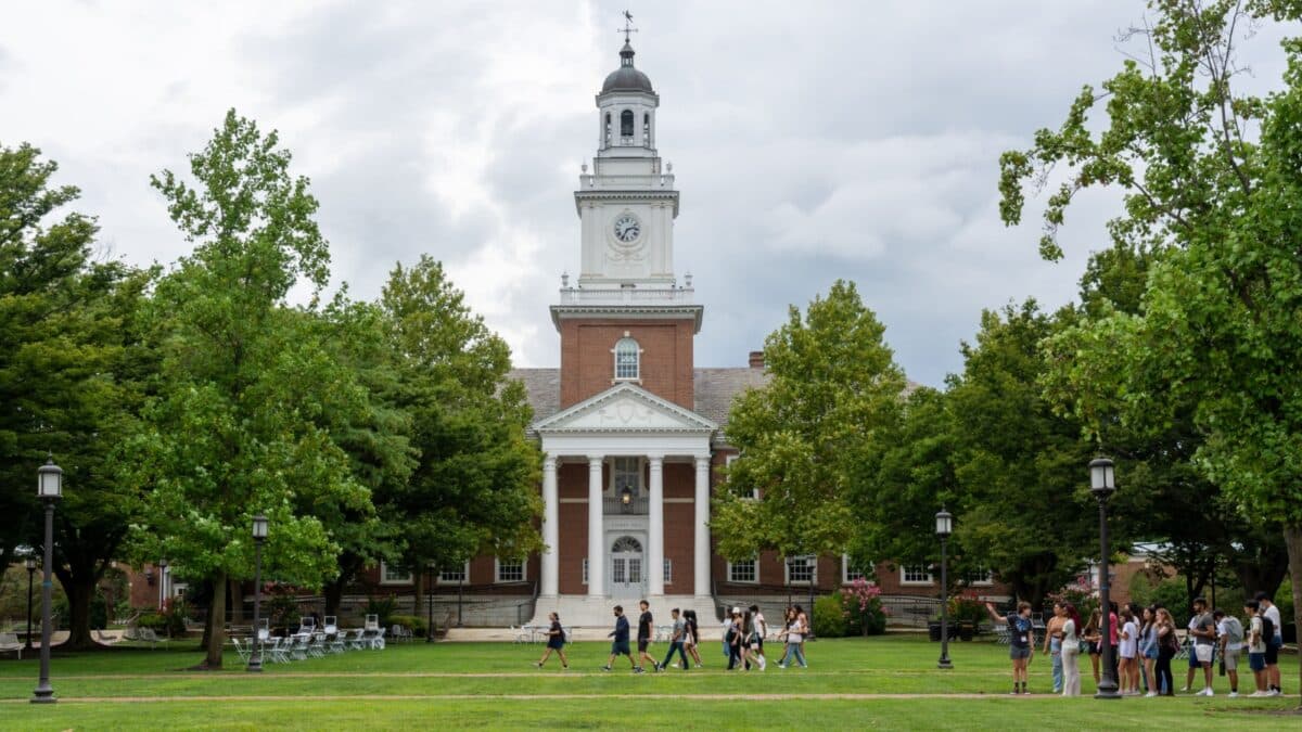 BALTIMORE, MARYLAND, AUGUST 21, 2022 - New students walk past Gilman Hall on the Johns Hopkins University campus during first year orientation