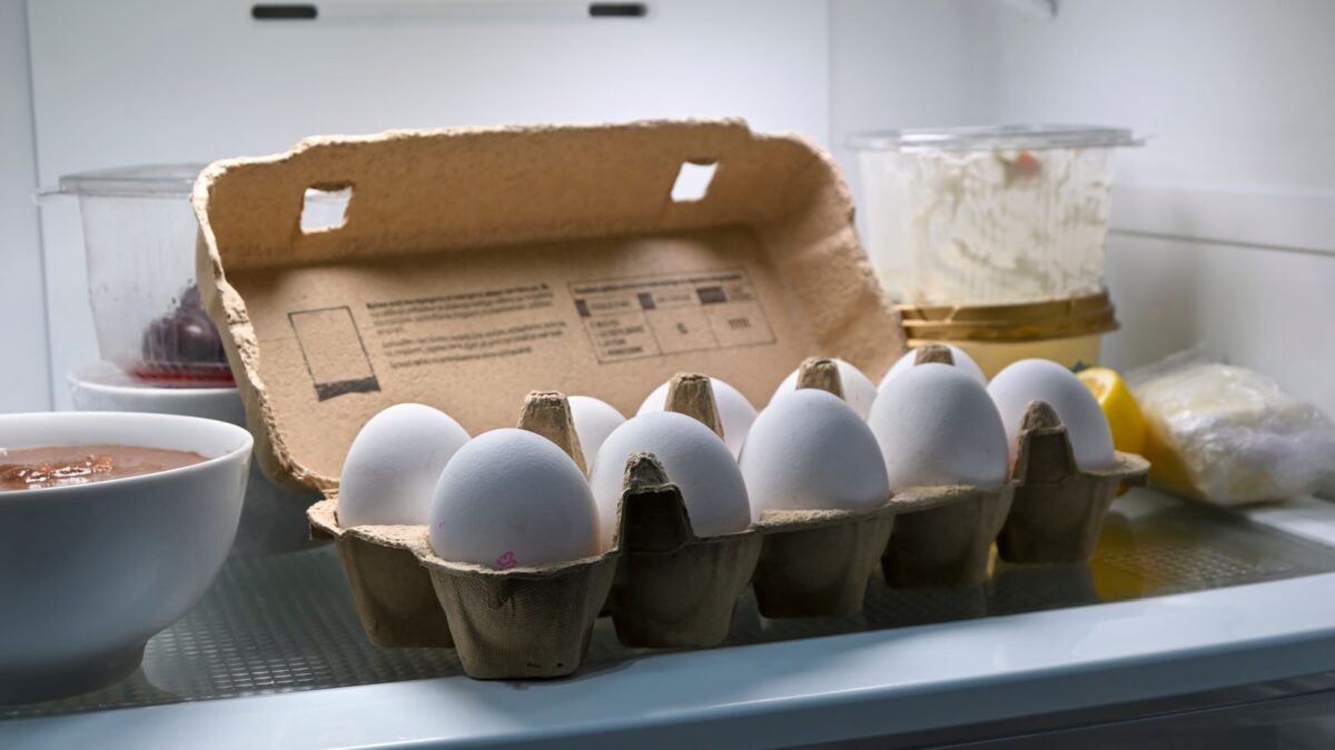 egg box with ten organic eggs inside a fridge