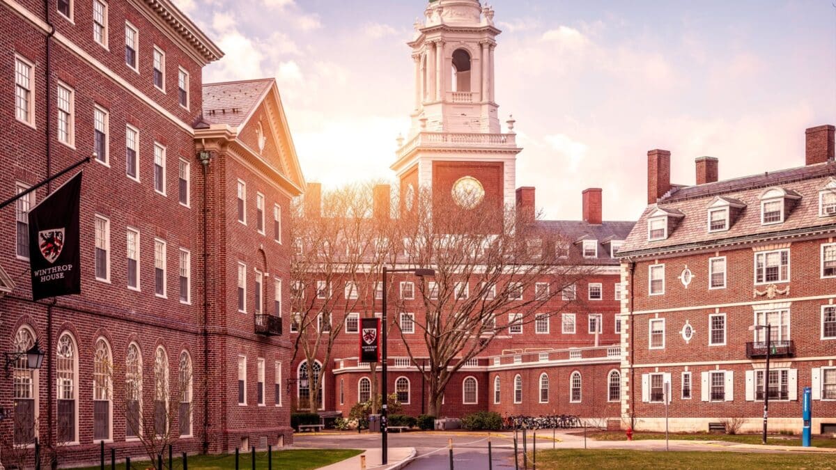 Cambridge, MA, USA - March 15, 2024: View of the architecture of the famous Harvard University in Cambridge, Massachusetts, USA showcasing it brick buildings with some students and locals passing by .