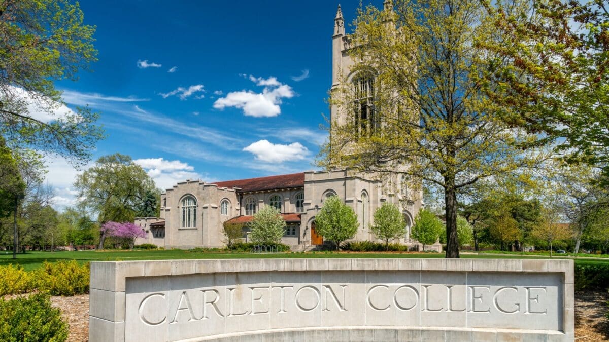 NORTHFIELD, MN, USA - MAY 10, 2021 - Entrance sign and Skinner Memorial Chapel on the campus of Carleton College.