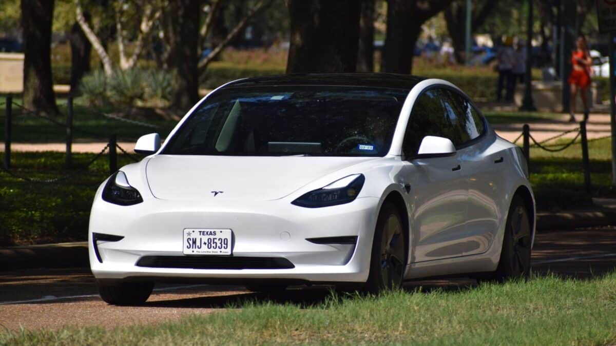 Houston TX, USA - 10-1-2023: A white Tesla (electric vehicle) cruising near Herman Park.