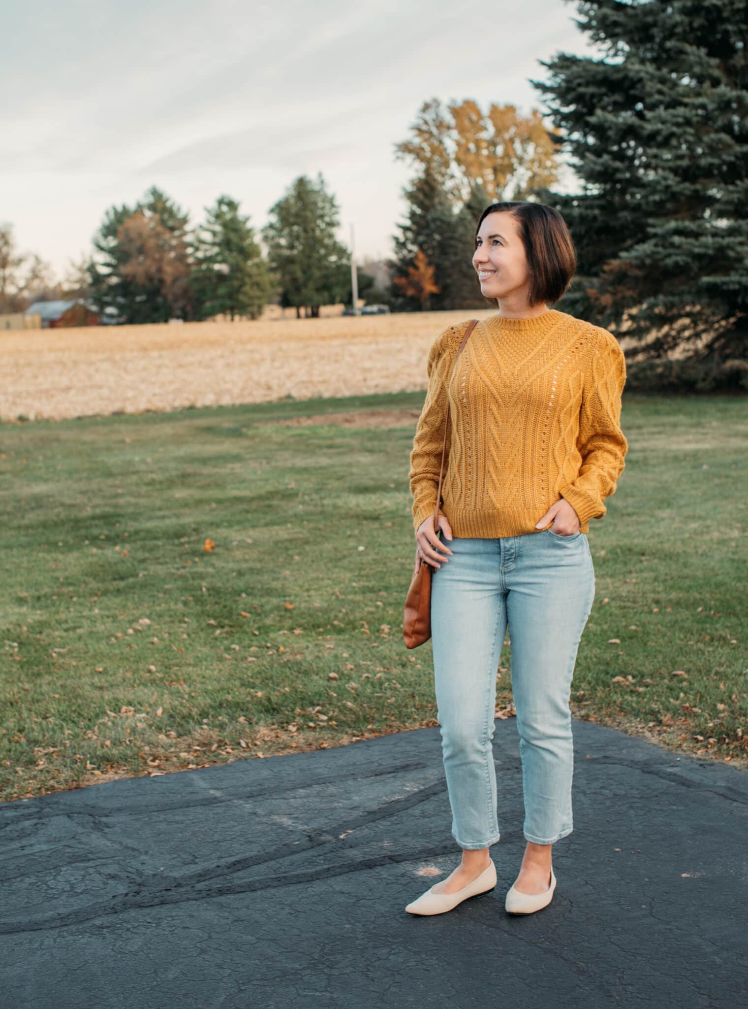 Lindsey wearing a yellow marie oliver sweater in fall