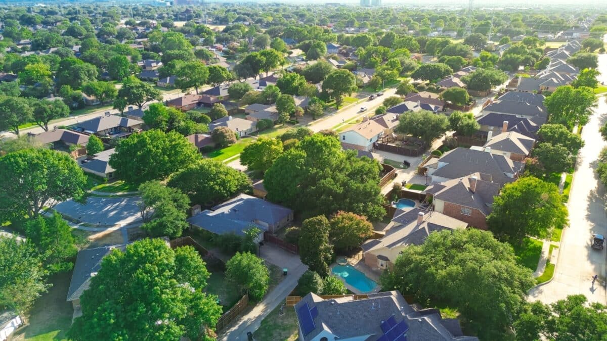 Tree lined residential street in upscale suburban Wentworth Estates neighborhood in West Plano, Texas, two-story single-family homes, swimming pool, suburbs Dallas Fort Worth metroplex, aerial. USA