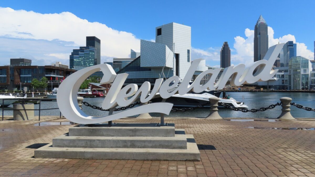 Cleveland, OH USA June 24 2024: Large script sign for Cleveland with skyscraper buildings in the background in Cleveland Ohio