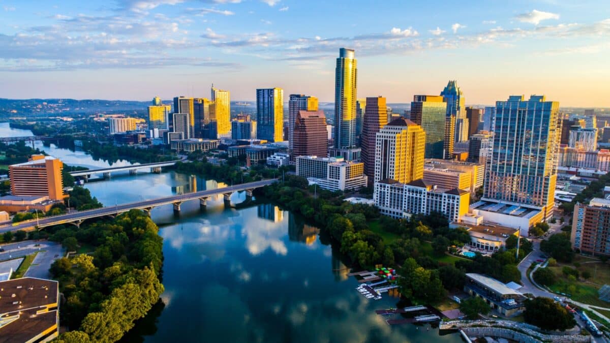 Austin Texas USA sunrise skyline cityscape over Town Lake or Lady Bird Lake with amazing reflection. Skyscrapers and Texas capital building in distance you can see the entire city during summer