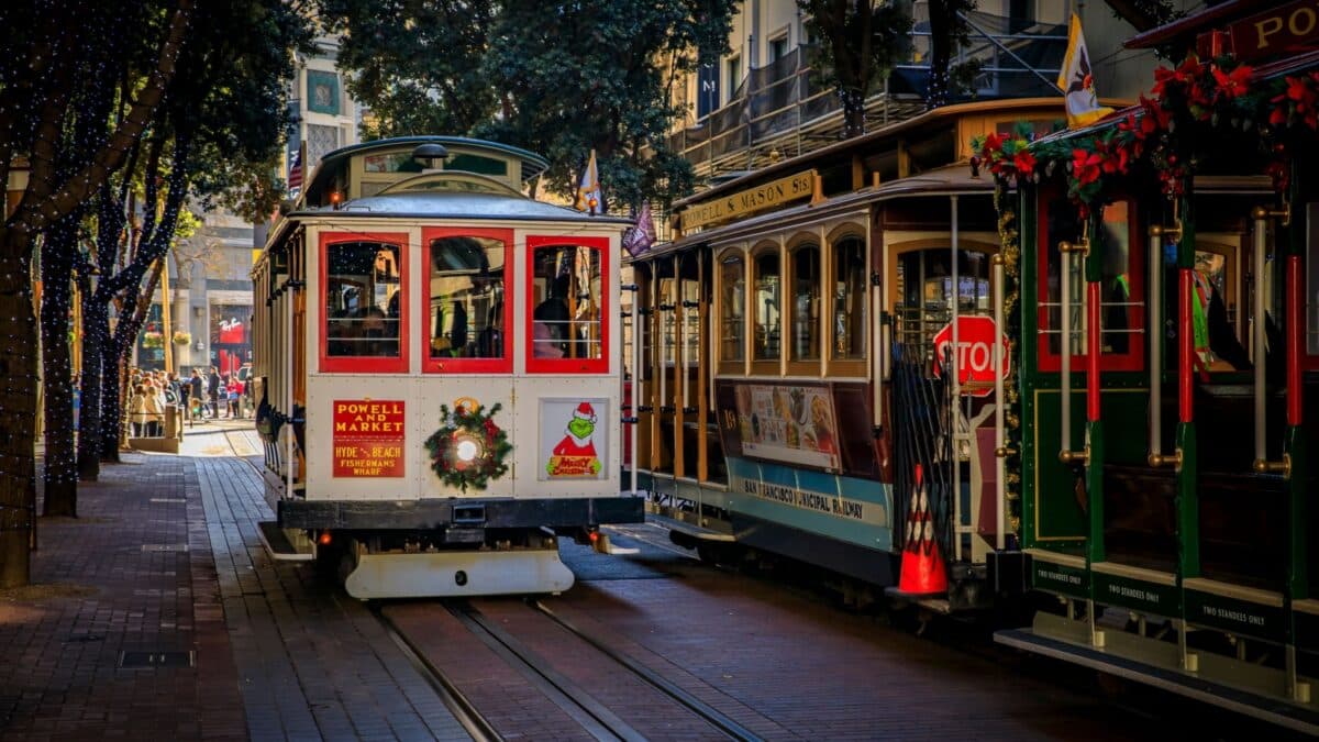 San Francisco, USA - December 18, 2021: The iconic cable car decorated with a wreath and trees with fairy lights for Christmas on Powell Street