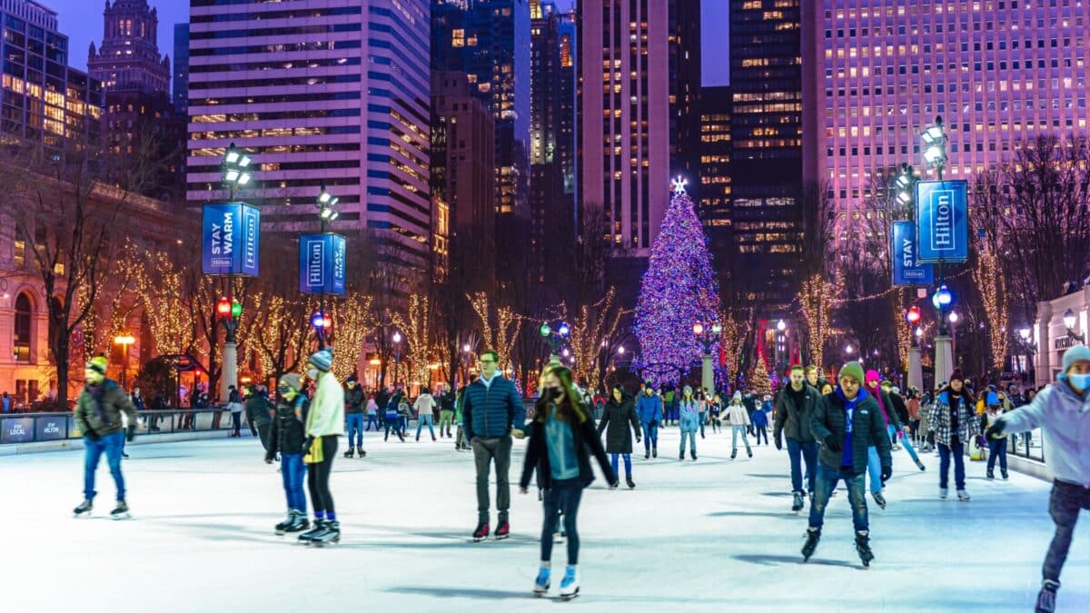 Chicago,Illinois,USA-December 29 2021 : People are enjoying ice skating during beautiful winter night in Millennium Park Ice Rink