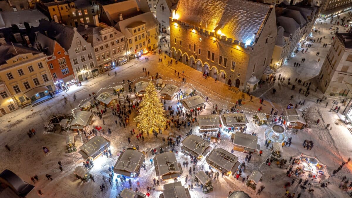 TALLINN, EE - Dec 26, 2021: An aerial view of illuminated Tallinn cityscape with Christmas Market in the center in Estonia