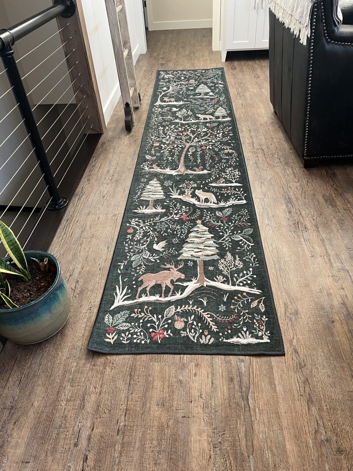 A Christmas rug by Ruggable on a wood floor 