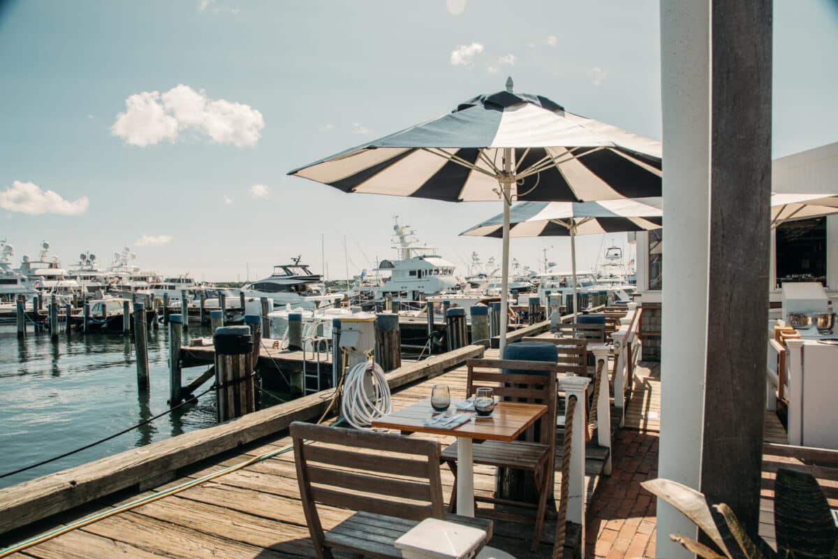 Outdoor dining in Nantucket with an umbrella and view of the water